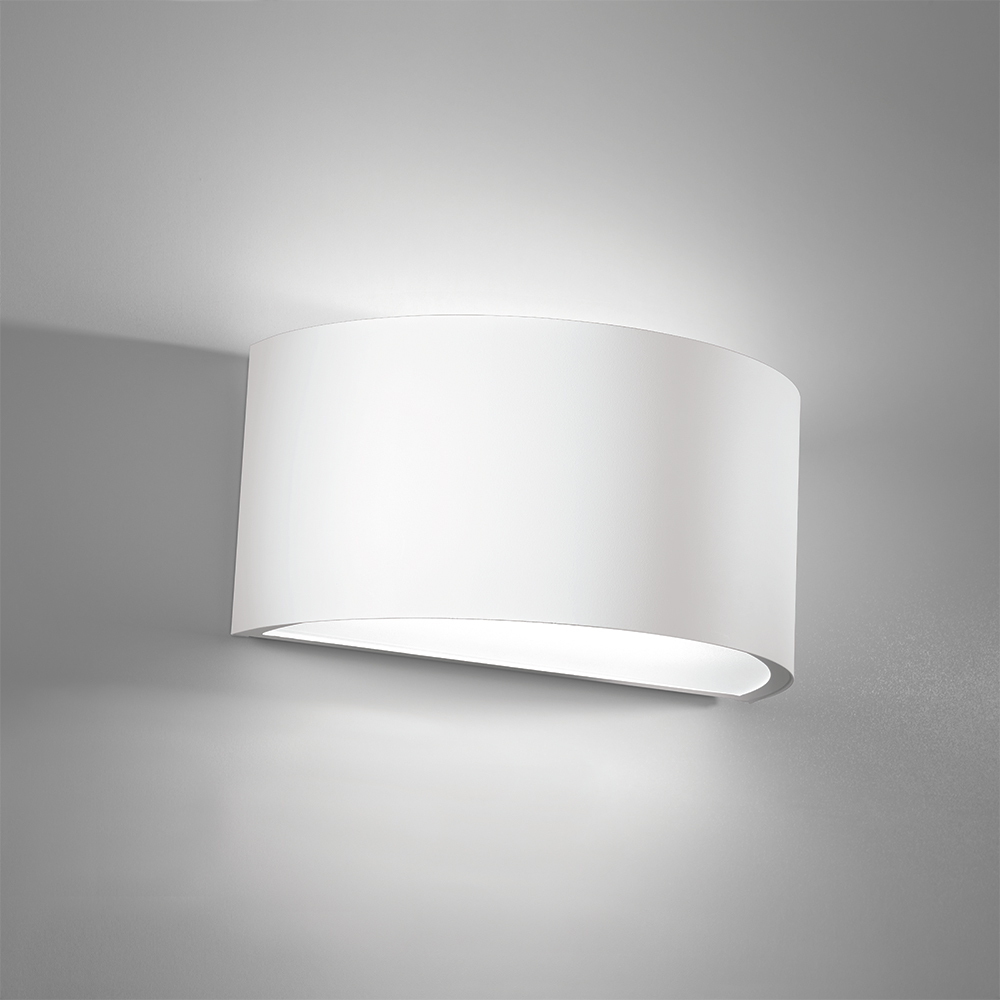 Curved wall sconce with a solid body and up and downlighting