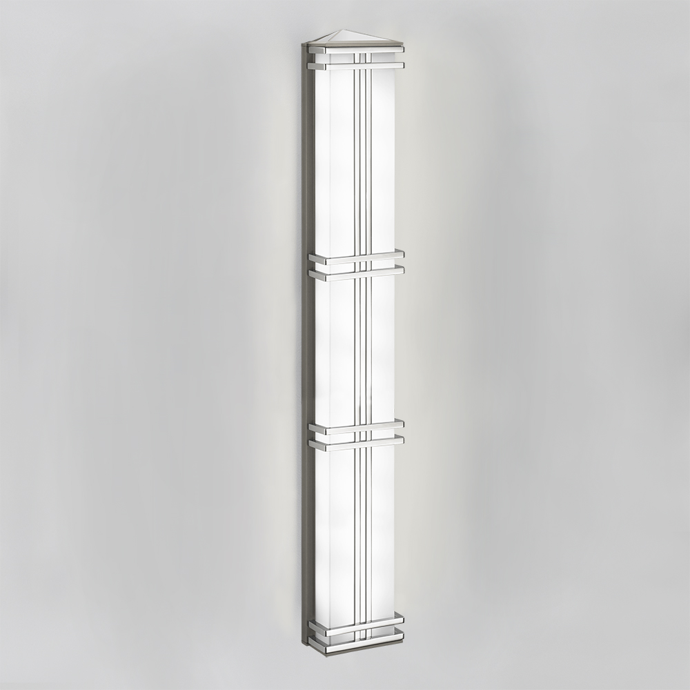 A classic architectural sconce with metallic frame and pointed top accent