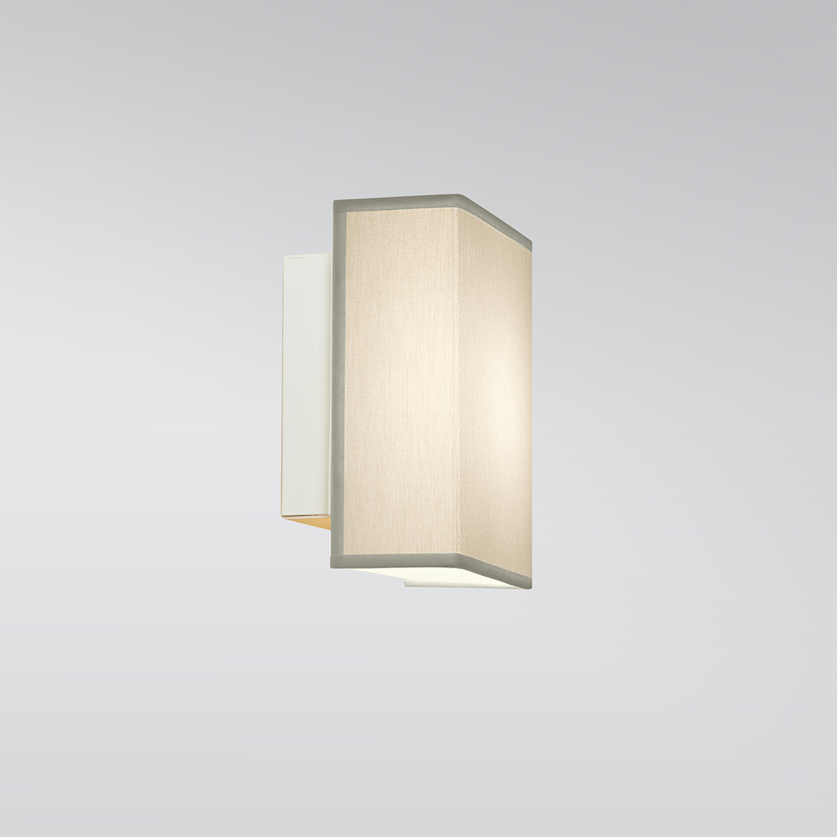 A small rectangular wall sconce with a fabric-looking shade