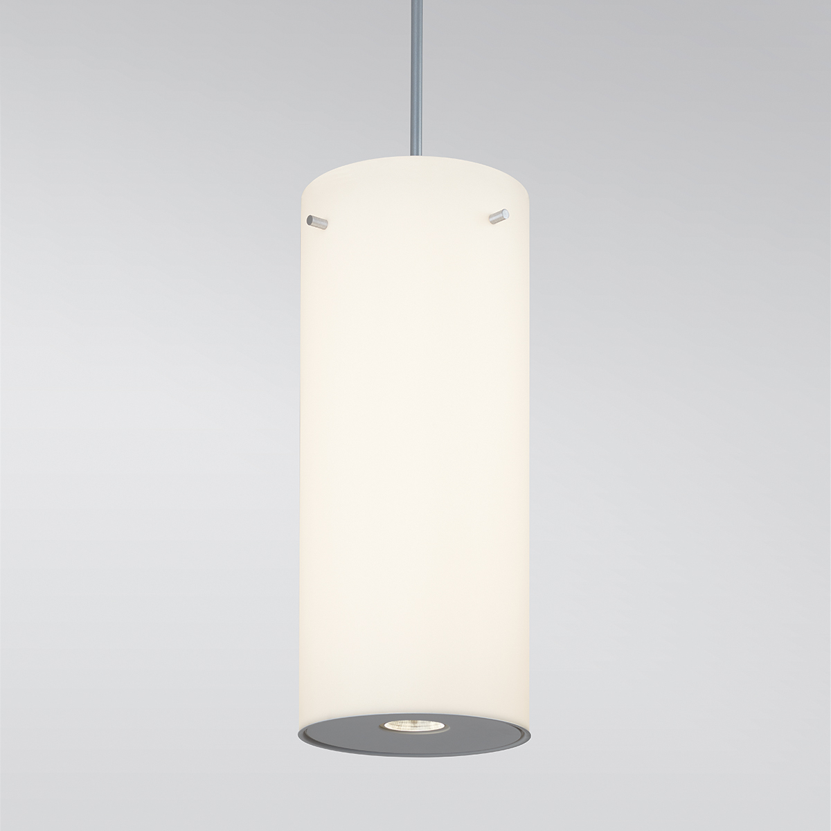 A large, luminous cylinder pendant with a pin accent