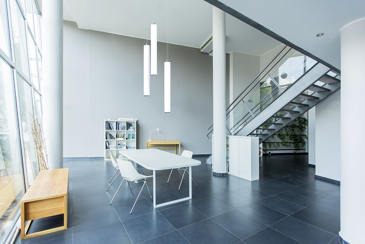 Office with desk and group of three luminous rectilinear pendants
