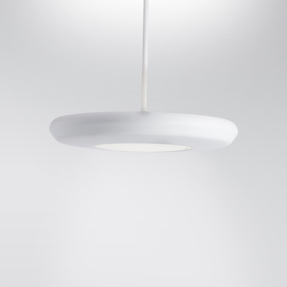 CP4450 Aries A round, disc-shaped pendant with a luminous downlight diffuser in the center