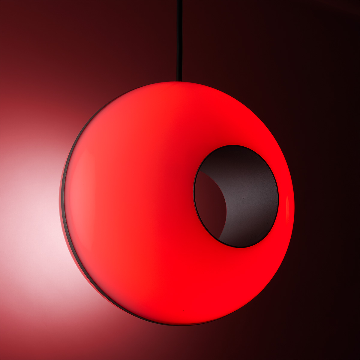 Globe pendant light for commercial spaces in RGB red light. 