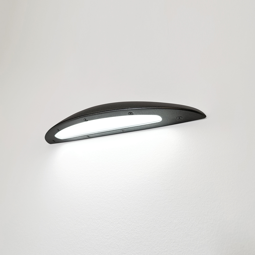 A down lighting wall sconce with a smooth, curved body