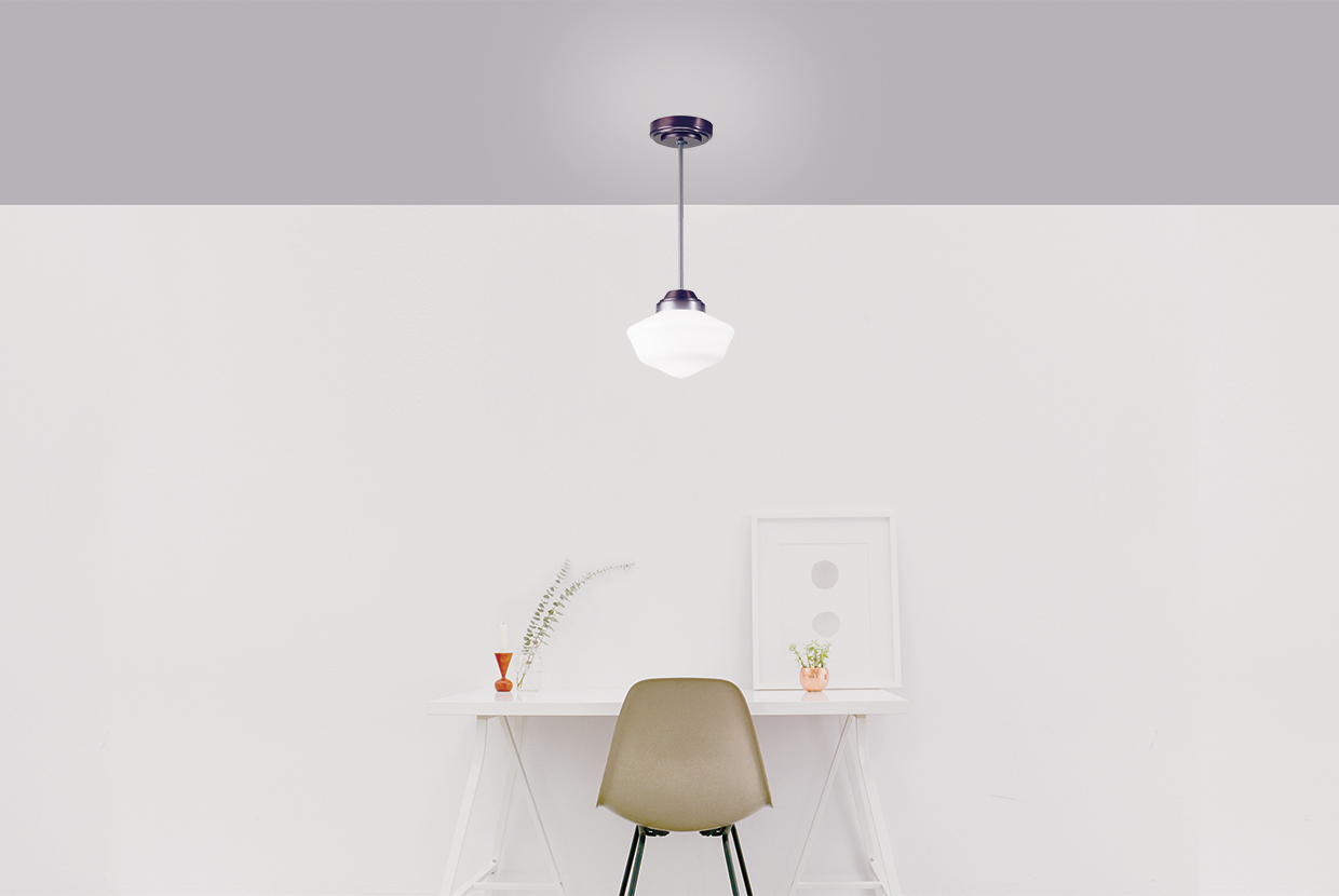 A classic school house style pendant over an individual desk