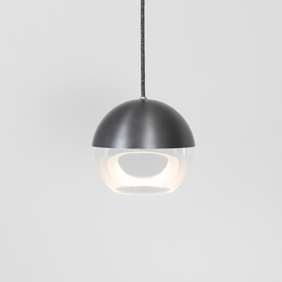 The 8” Muse pendant light globe utilizes a source disk that floats while reflecting indirect light.