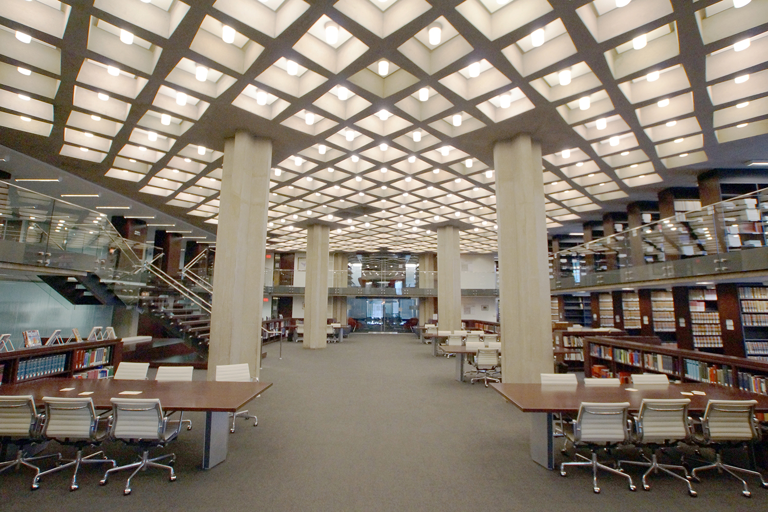 Cane cylinder ceiling luminaires in education lighting design, seen here mounted in recessed square cutouts above a campus library.