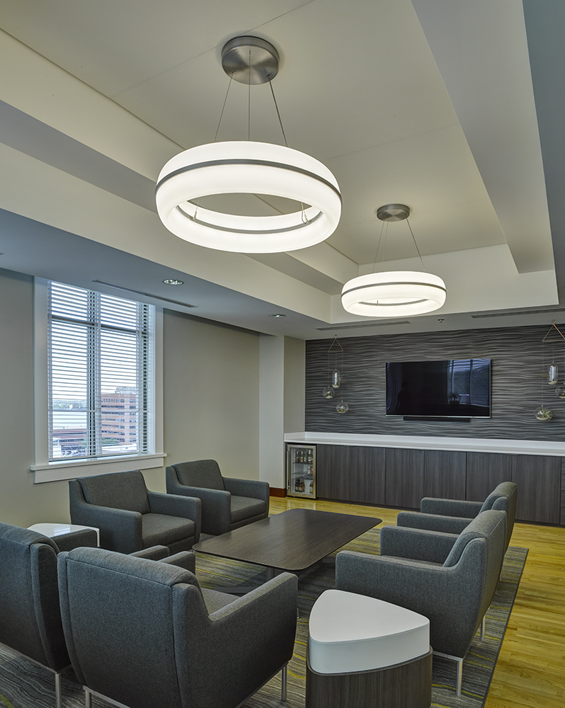 Meridian Round pendant is perfect for office lighting, seen here above a comfortable meeting area in a modern design office.