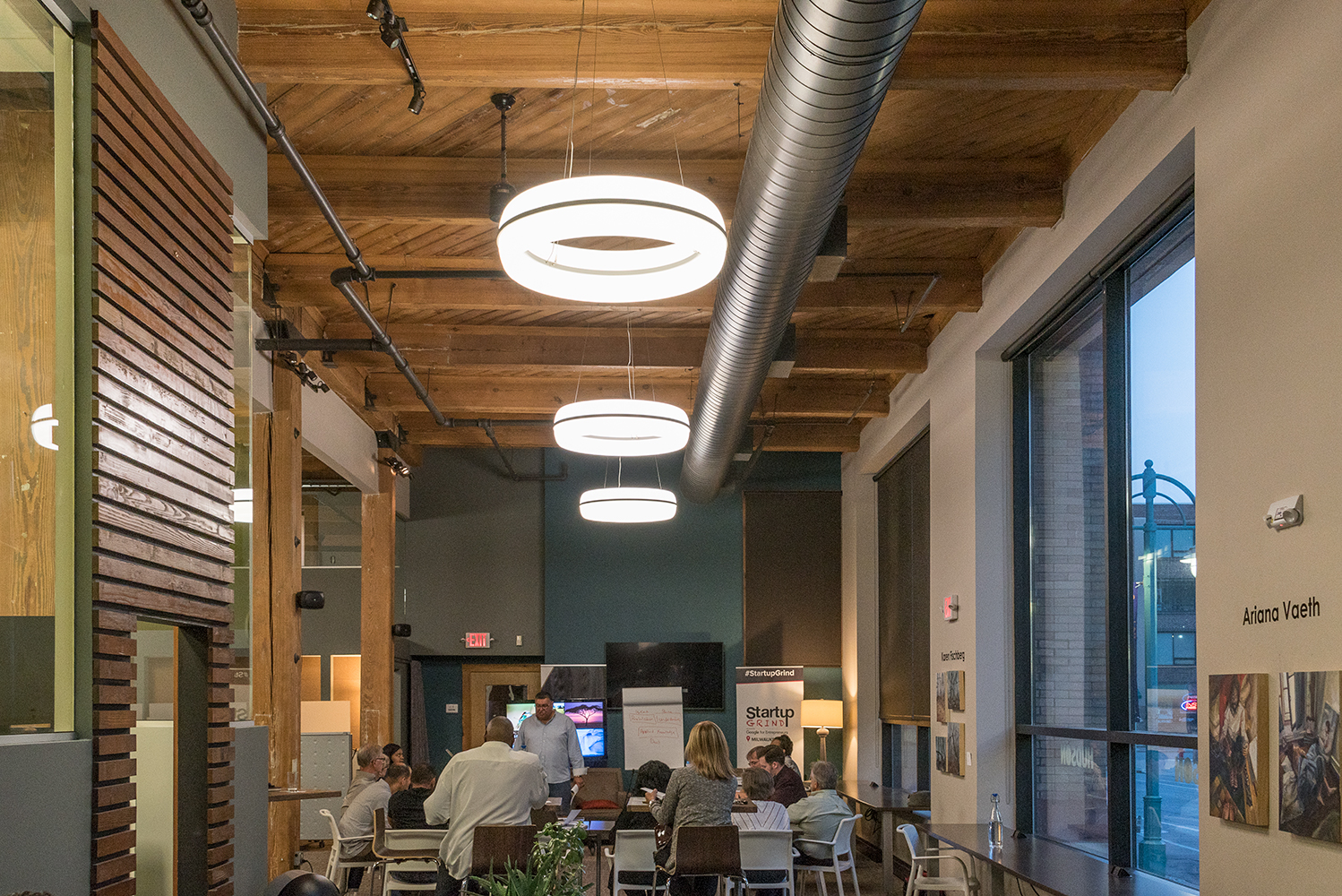 Meridian Round pendant is perfect for office lighting, seen here above a casual café area in a large office building.