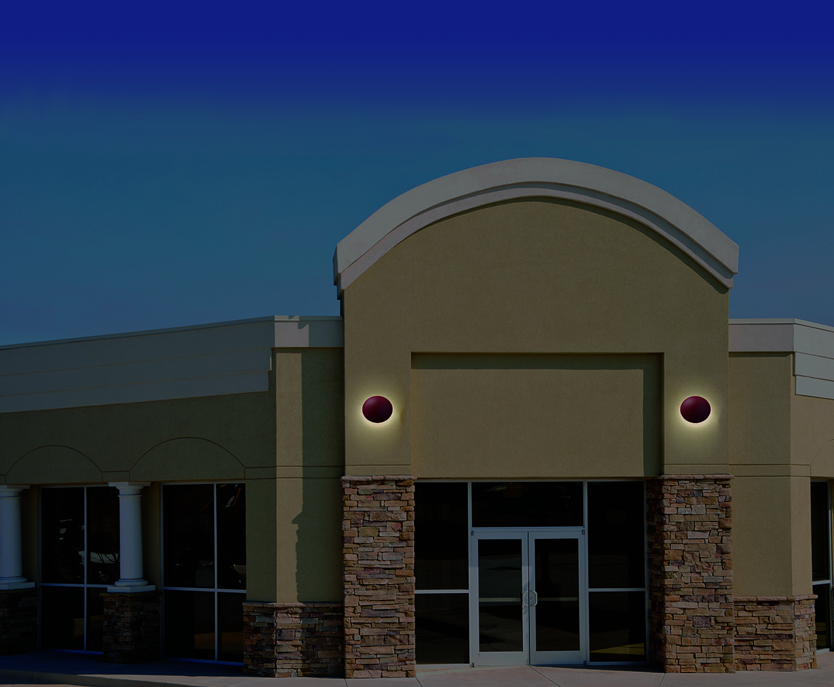 Northridge exterior lighting fixtures provide soft illumination on a commercial exterior entryway.