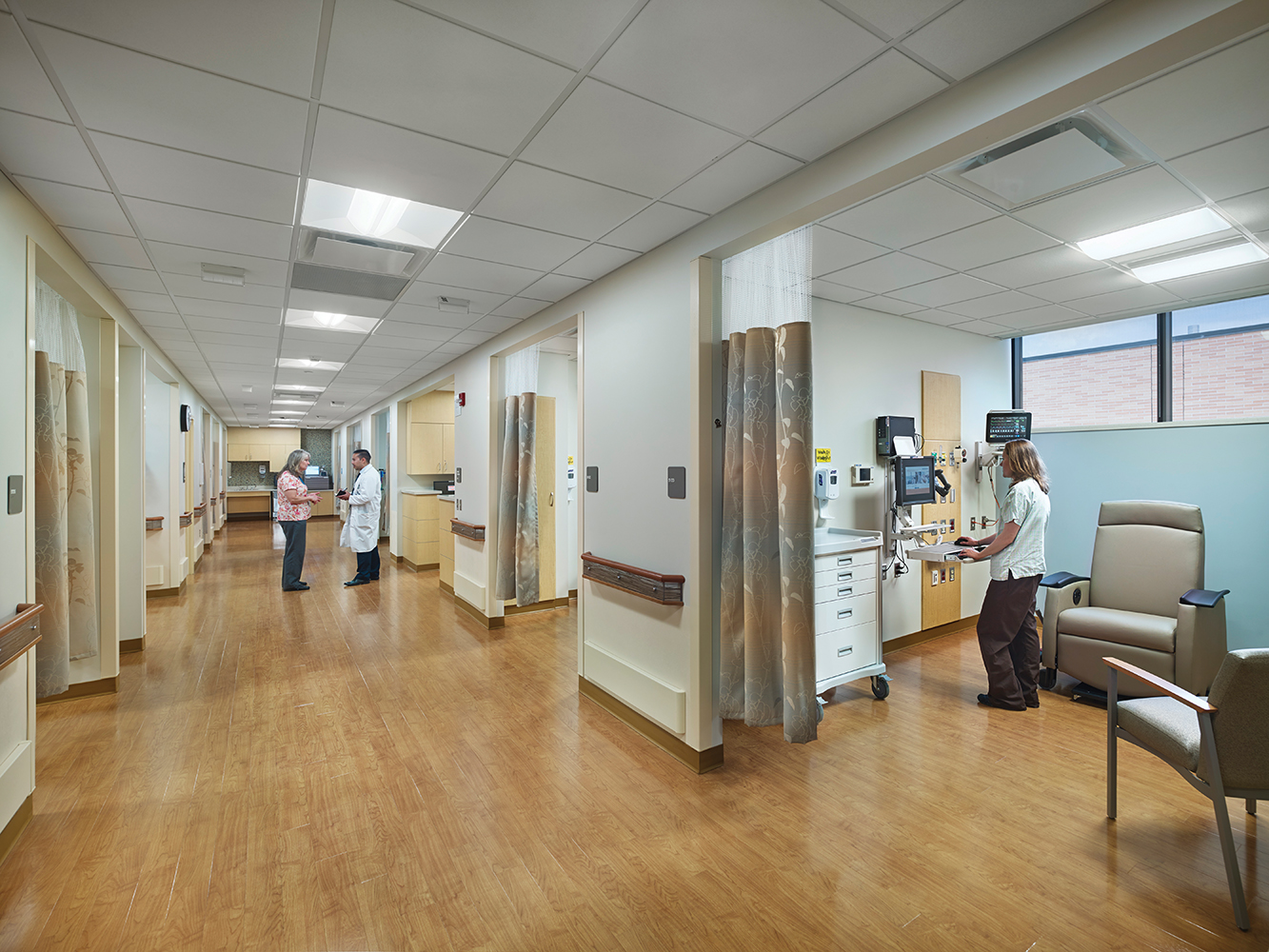 Unity medical lighting over an exam area in a wide emergency room corridor.